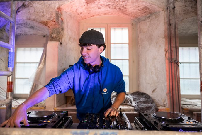 DJ Bild Ein DJ steht an den Plattentellern.